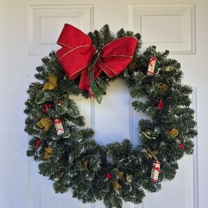 Elegant Holiday Wreath with Red Bow and Gold Details